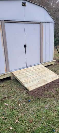 White shed door repair project by A Legacy Handyman