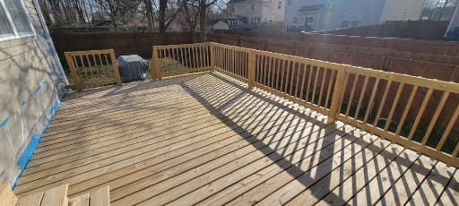 Deck railing and backyard deck project by A Legacy Handyman
