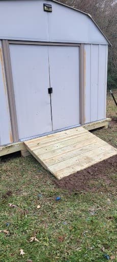 White shed door repair project by A Legacy Handyman