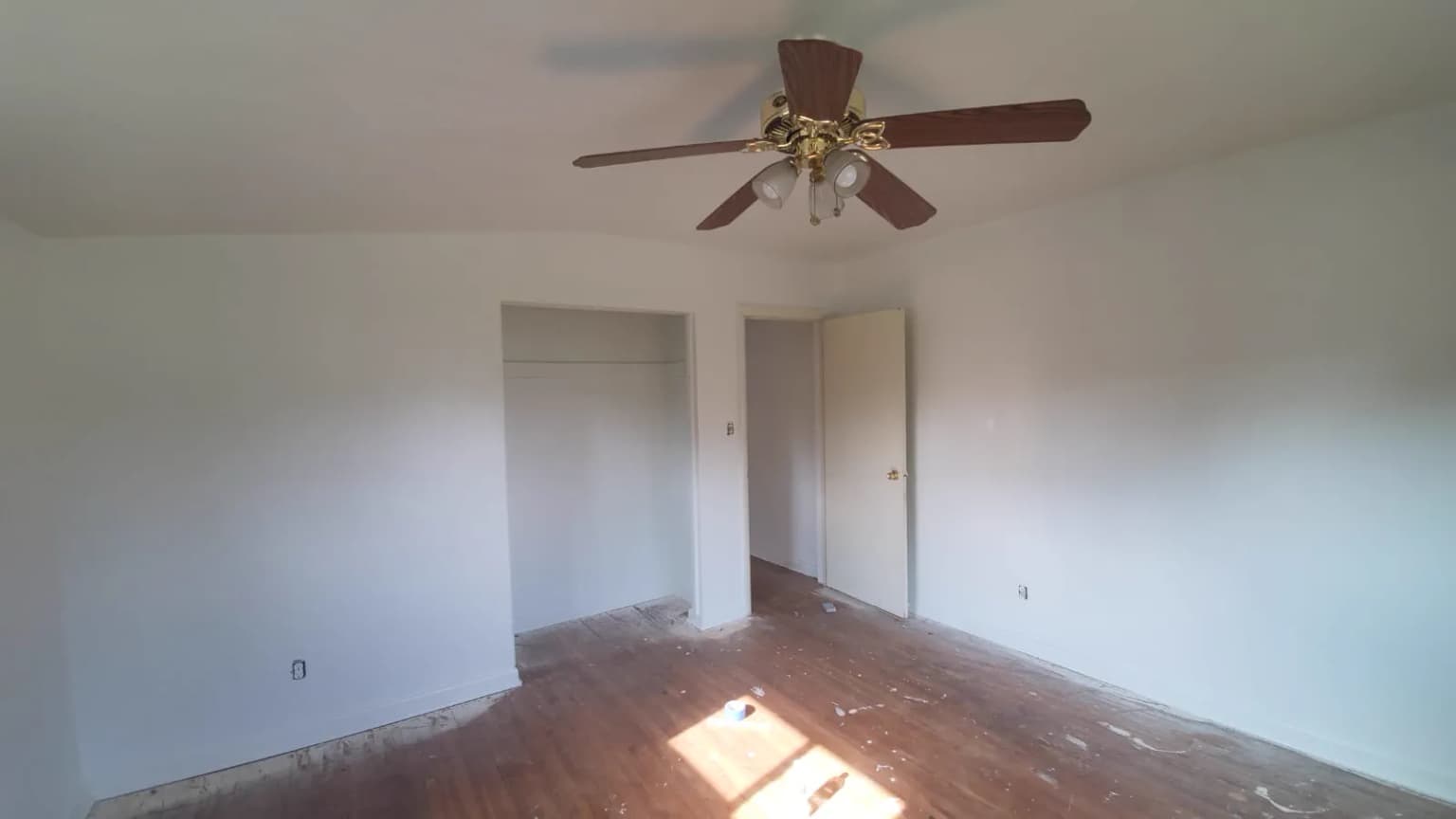 Finished room with ceiling fan and light fixture installed