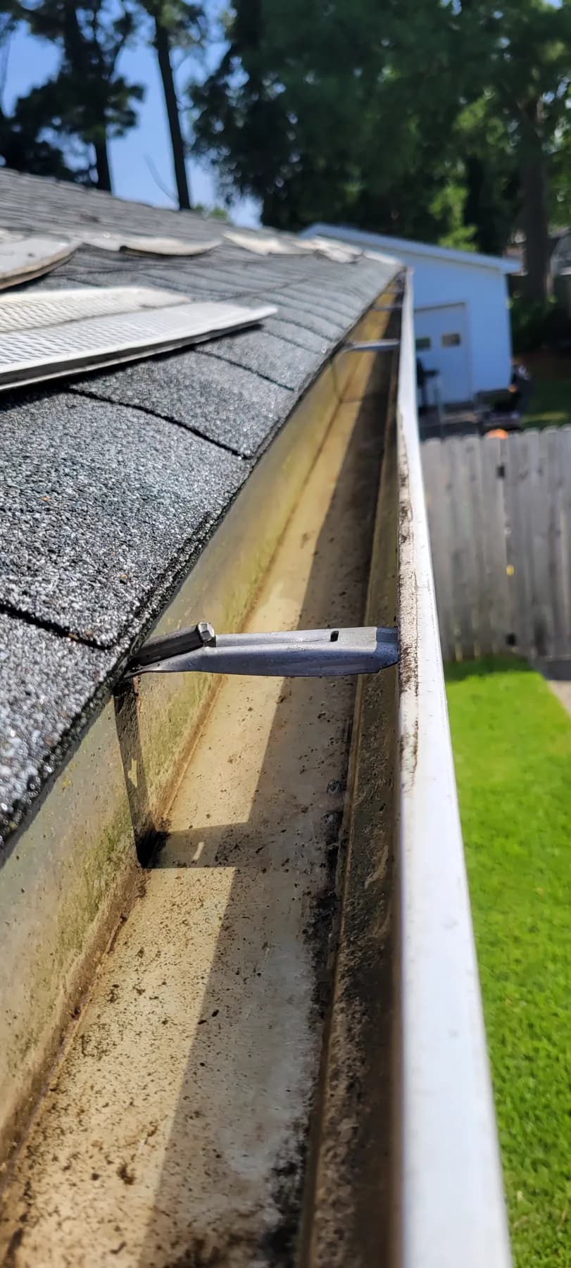 Gutter and fascia repair detail along a home roofline
