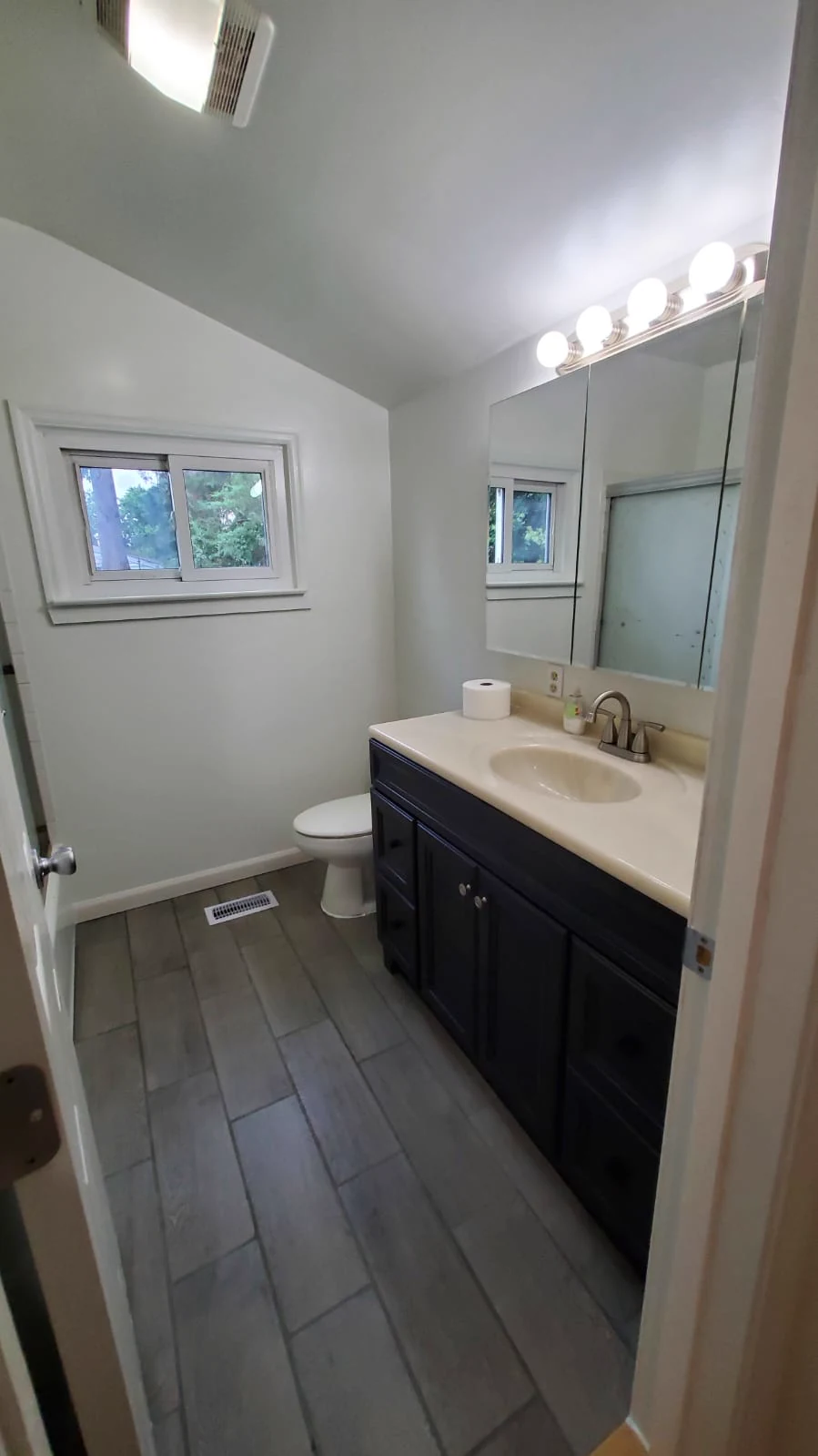 Finished bathroom vanity replacement with cabinet, countertop, and mirror